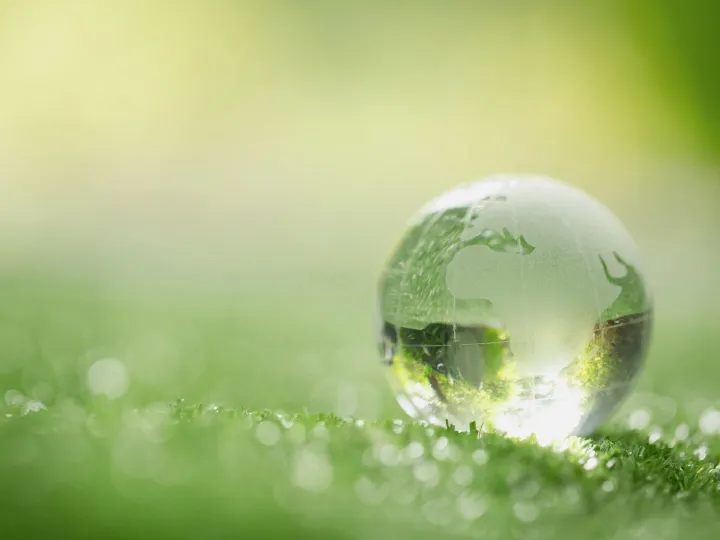 Close up of crystal globe resting on grass in a