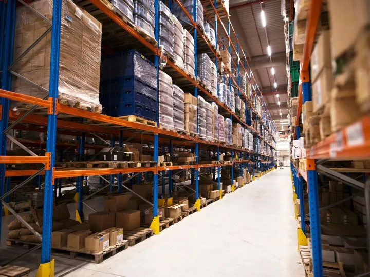 Interior of large distribution warehouse with shelves stacke