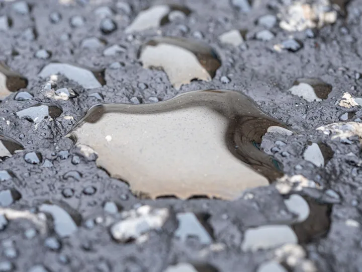 Detailed view of wet asphalt surface showing