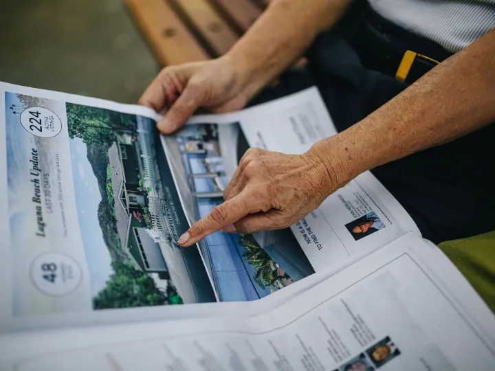 A senior adult's hands holding and reading a