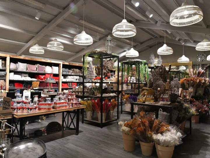 Inside an independent gift shop, with shelves of giftware and flowers