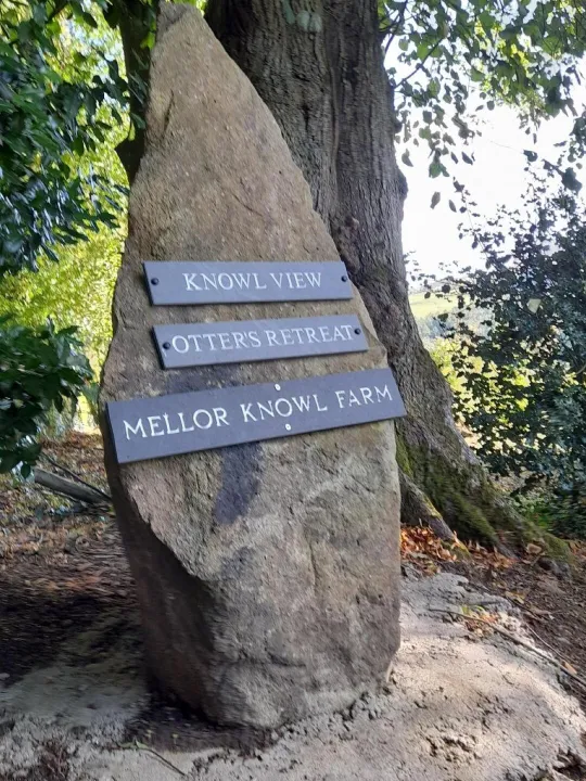 The stone signpost to Otters Retreat at the entrance to Mellor Knowl Farm