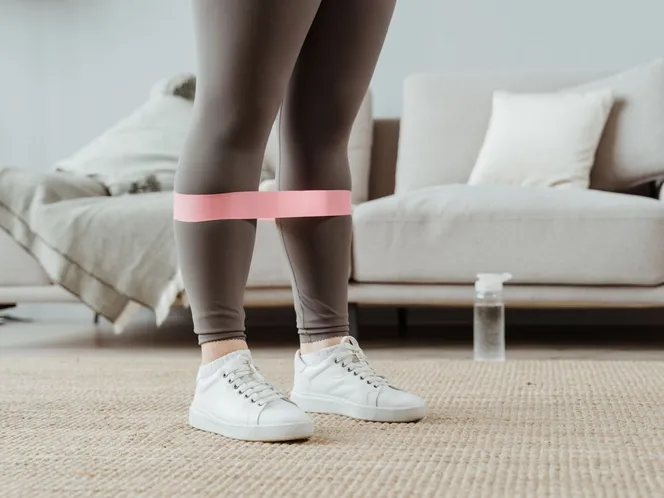 Resistance band worn around the ankles during exercise