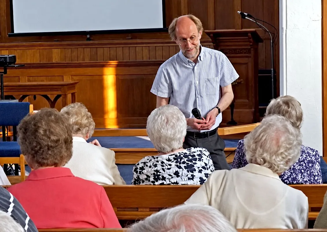 Andrew talking to a seated congregation in a Methodist chapel