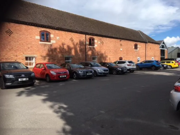Park View Business Centre, a red-brick former farm building with cars parked outside