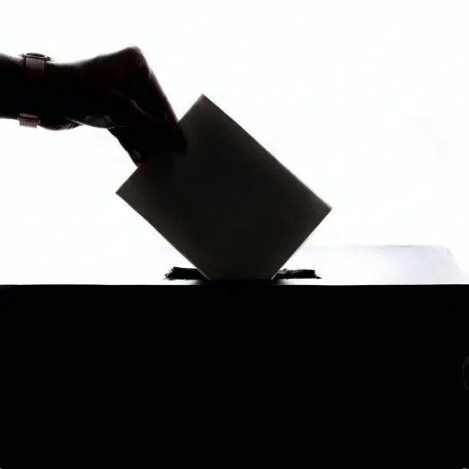 Person Dropping Paper On Box