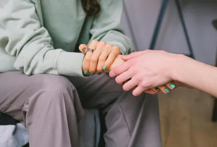 Crop psychologist supporting patient during counseling indoors