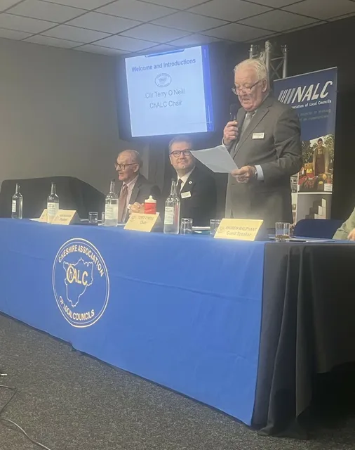 A speaker addressing the meeting from behind the blue ChALC top table