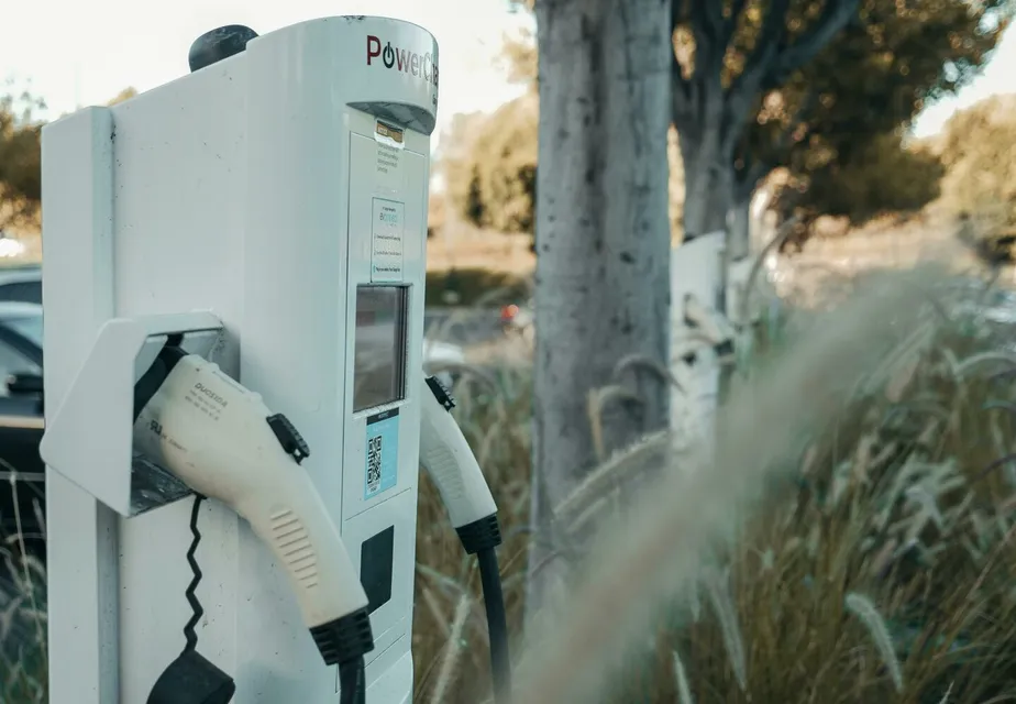 Electric vehicle charging station in an outdoor natural setting, highlighting sustainable technology.