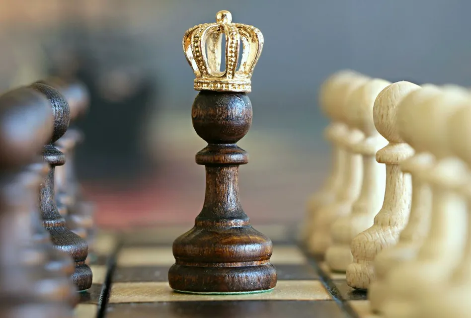 A brown pawn with a crown stands prominently on a chessboard, symbolizing strategic play.