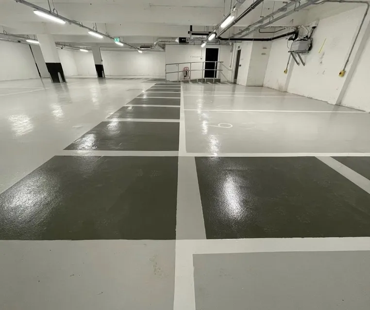 Glossy underground parking lot with marked spaces