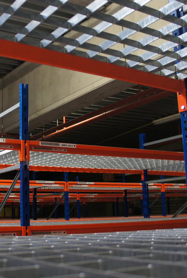 Newly painted warehouse shelving with blue columns and red beams