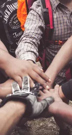 A group of diverse individuals join hands for