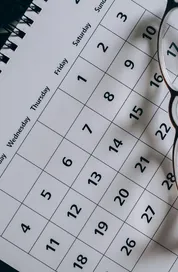 A close-up of a January calendar with eyeglasses