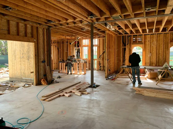 Workers constructing a house framework