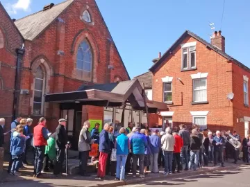 Ecumencial walk of witness on Good Friday pauses outside Wesley Centre-