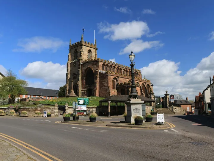 A historic stone church under a bright blue sky
