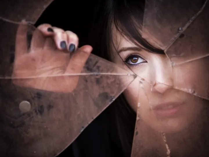 Woman's face at broken window