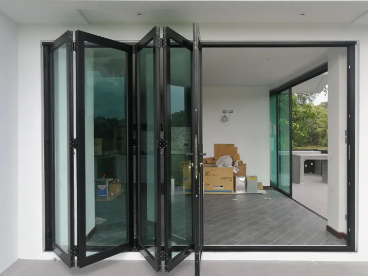 A black bifold door on the patio