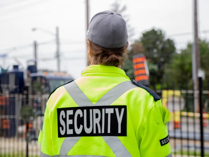Woman in yellow security jacket
