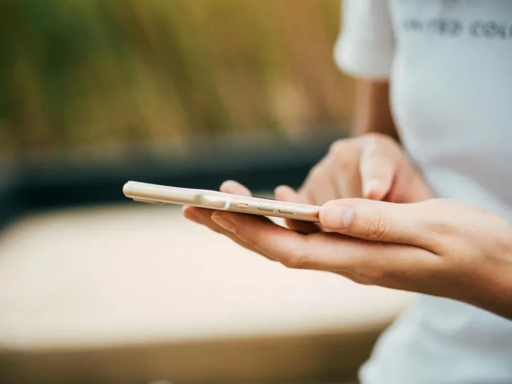 Close-up of a person using a smartphone outdoors