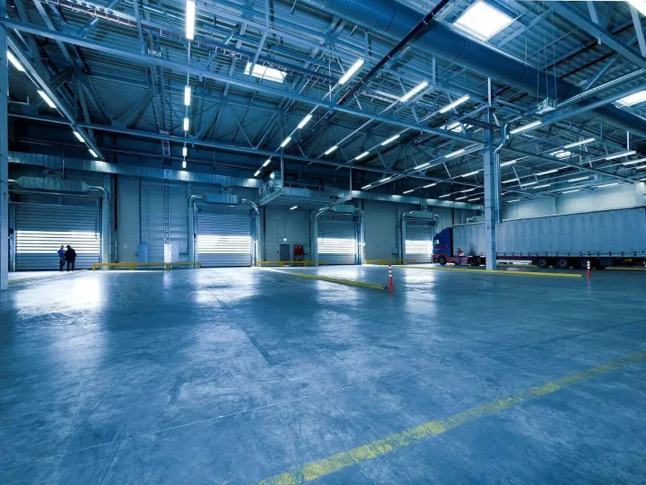 Large warehouse interior with docked truck, ideal 