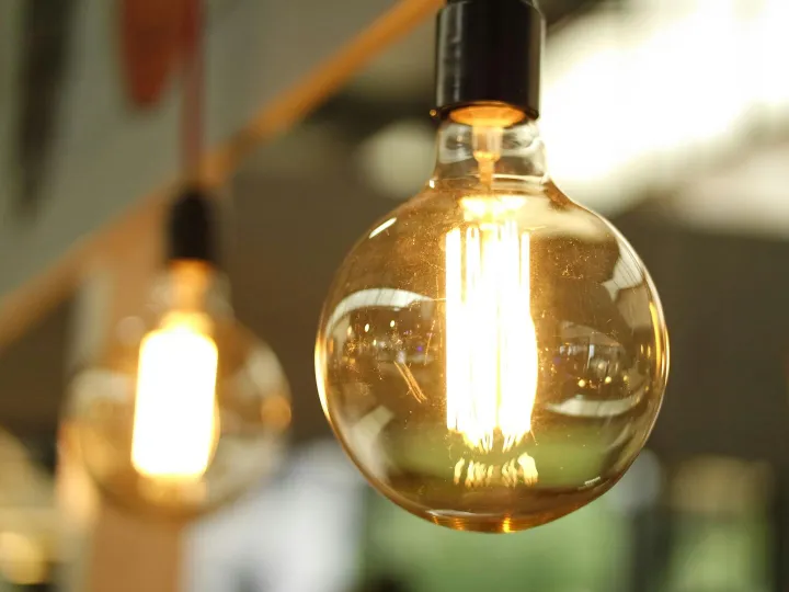 A close-up of a glowing vintage Edison bulb