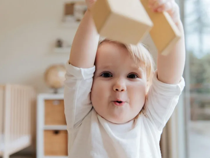 Adorable baby enjoying playtime with wooden