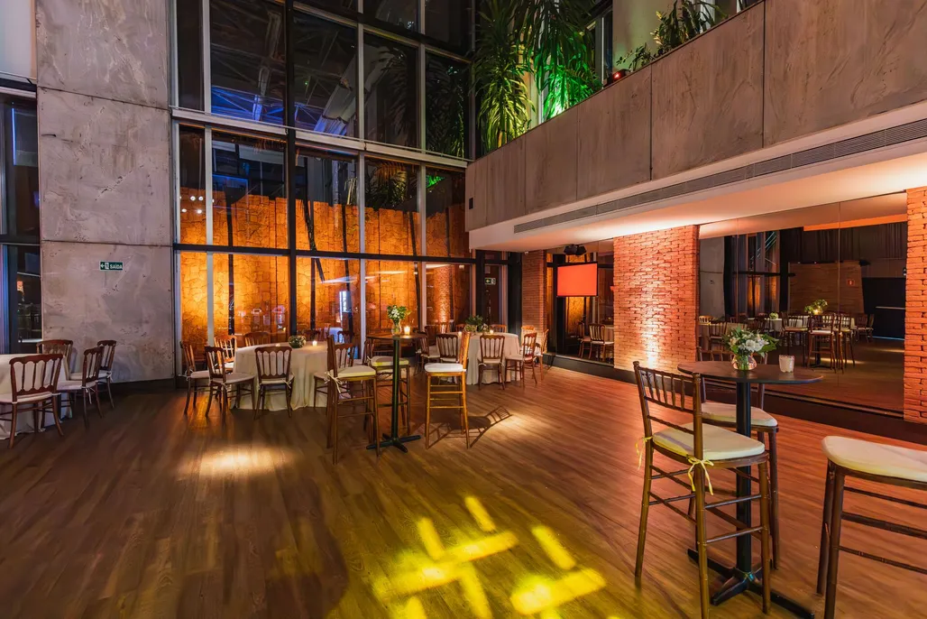 A bright hall set out with tables and chairs for an event