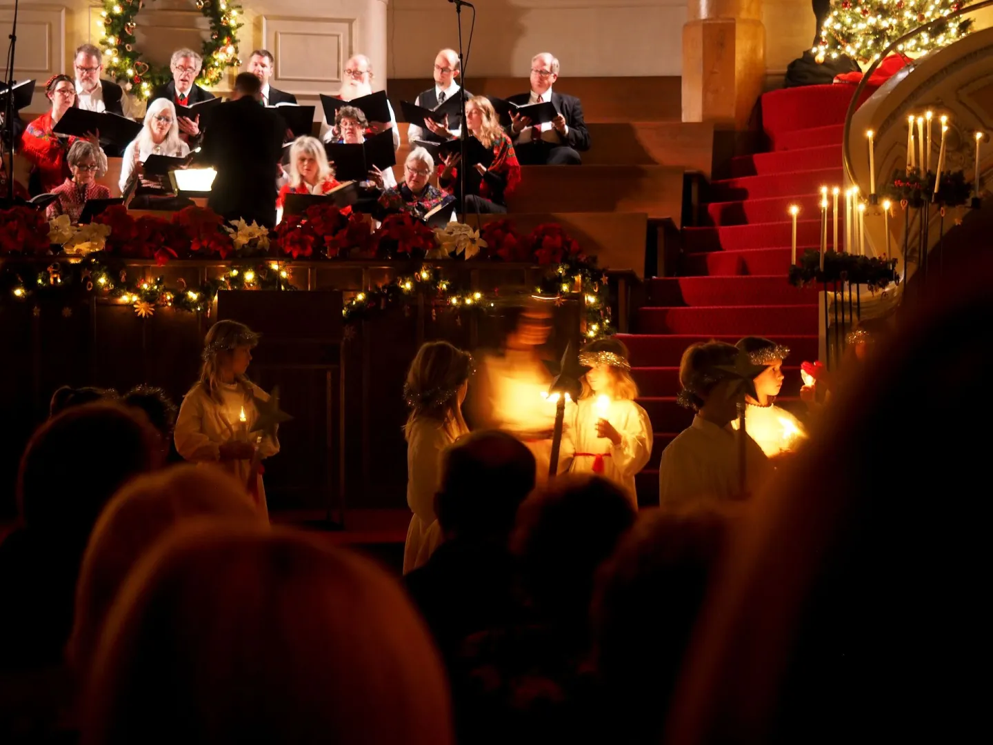 Choir and children with candles at a Christmas carol service