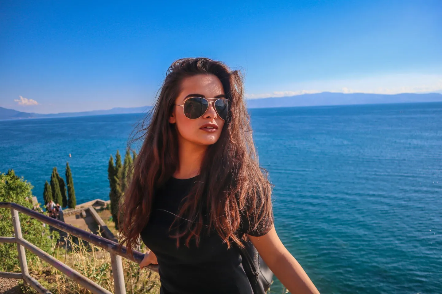 A woman with sunglasses relaxes by the serene
