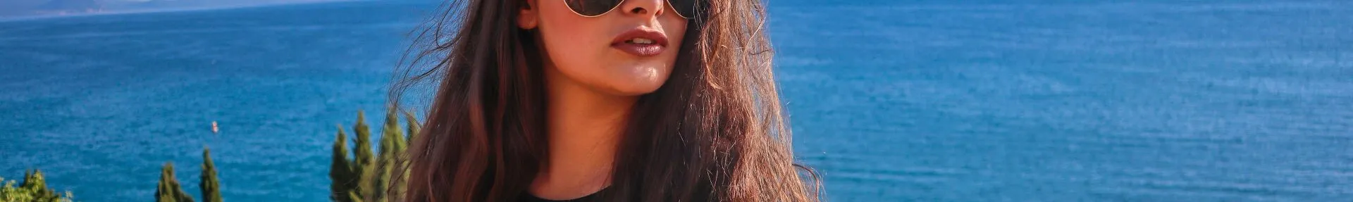 A woman with sunglasses relaxes by the serene