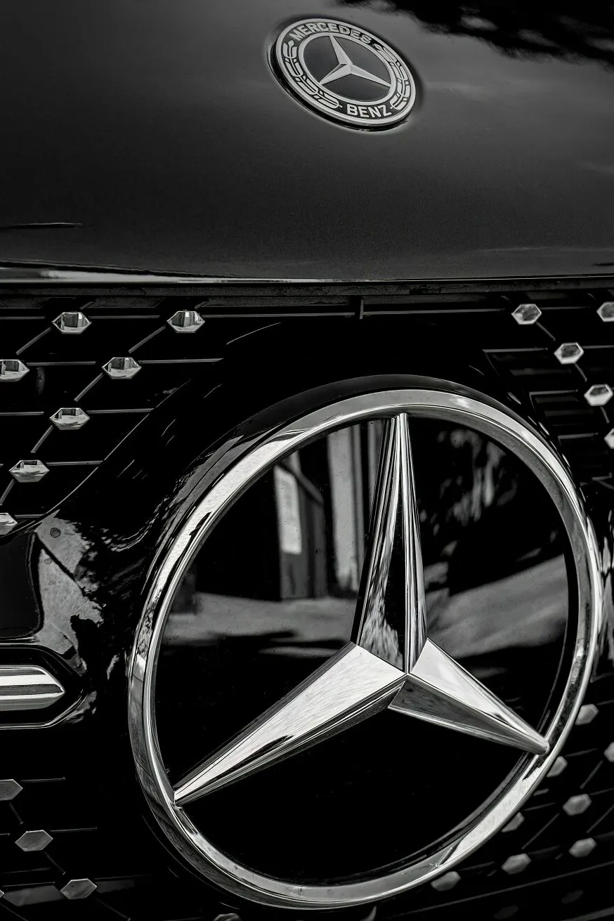 Detailed close-up of a Mercedes-Benz emblem on a