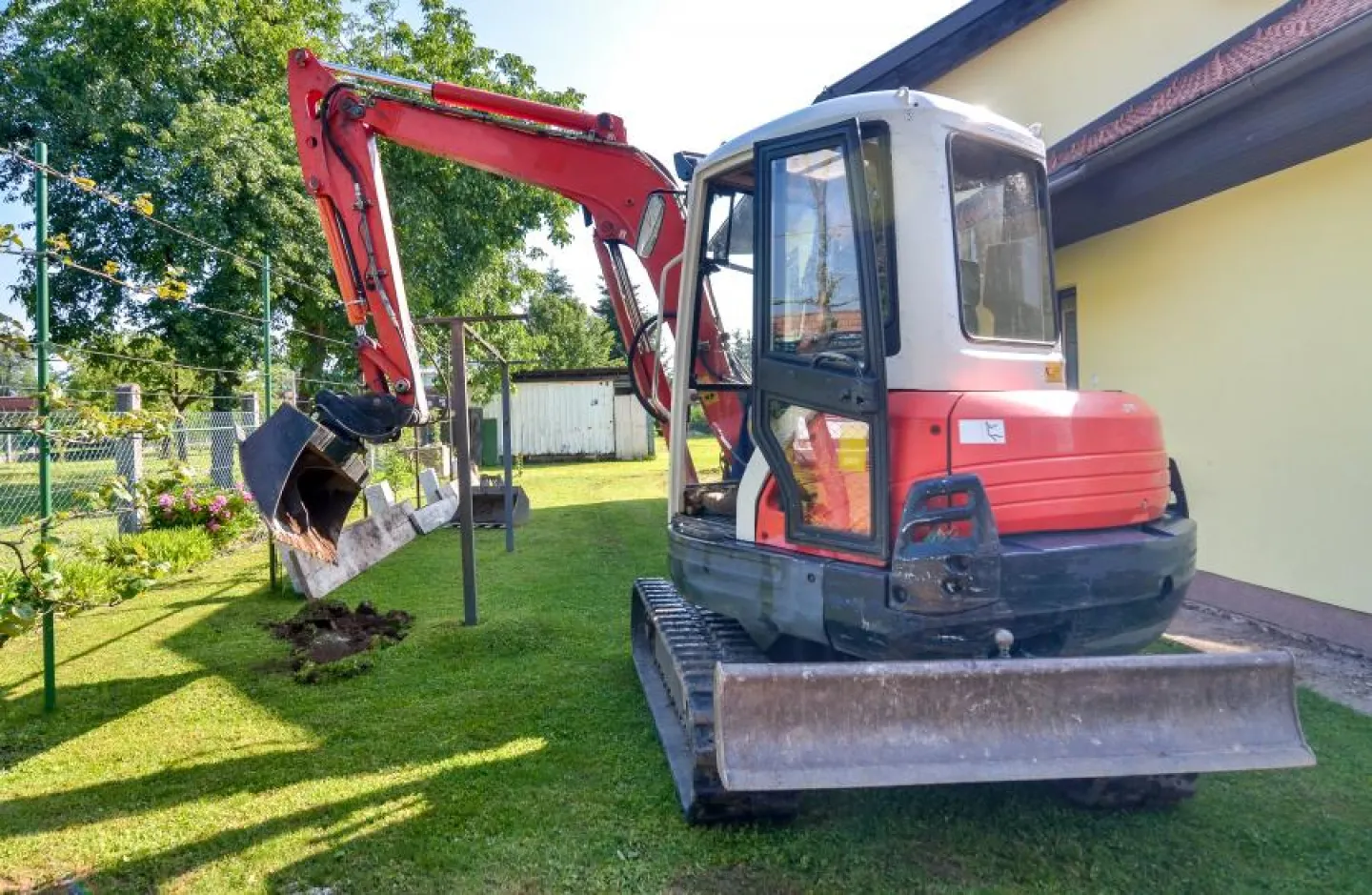 Mini digger in a domestic garden