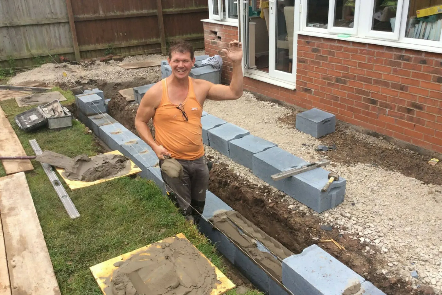 Dave Reynolds, owner of Nantwich Building Services, smiling on-site during a home extension project.