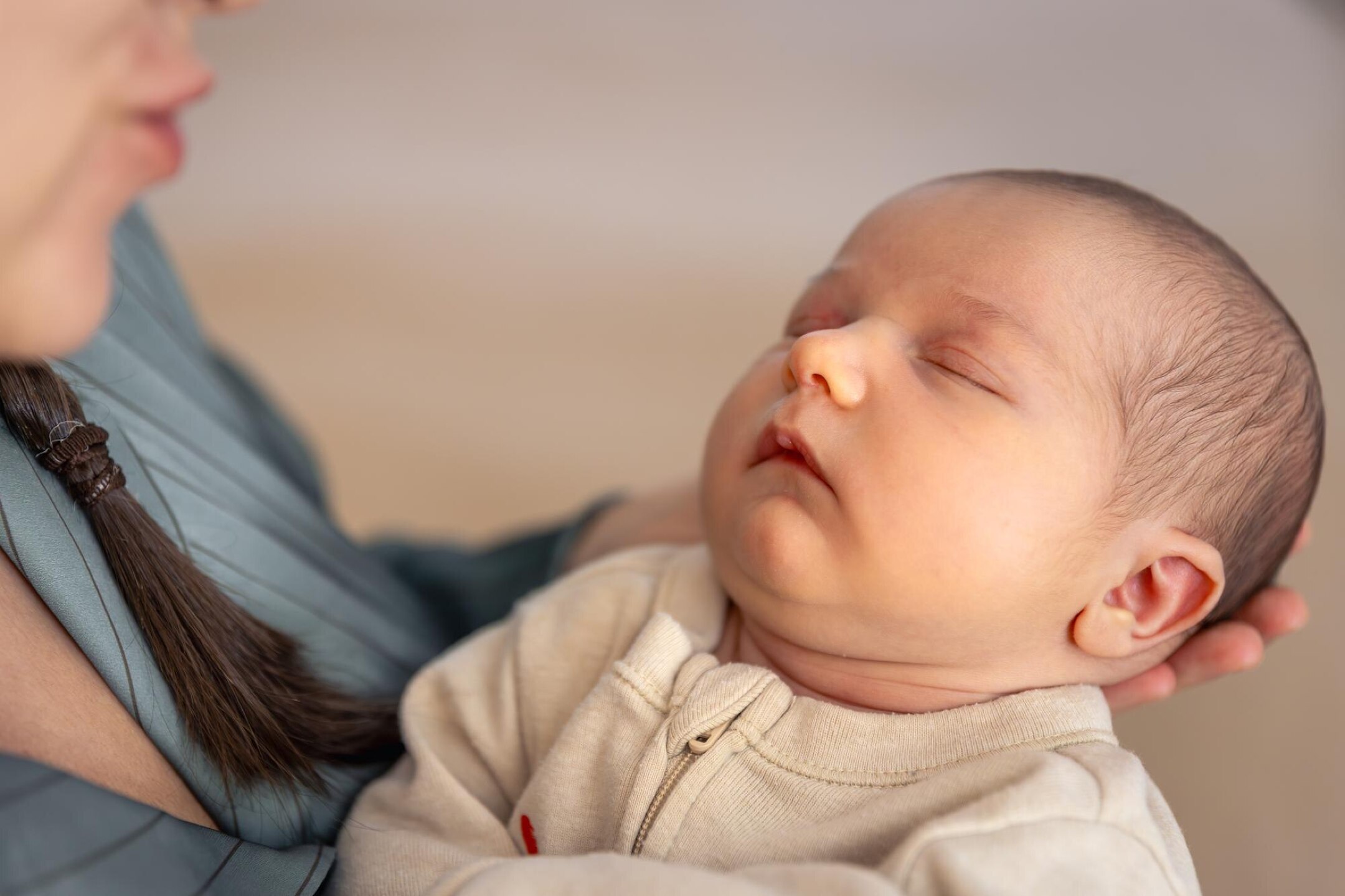A young mother with a newborn baby Newborn baby