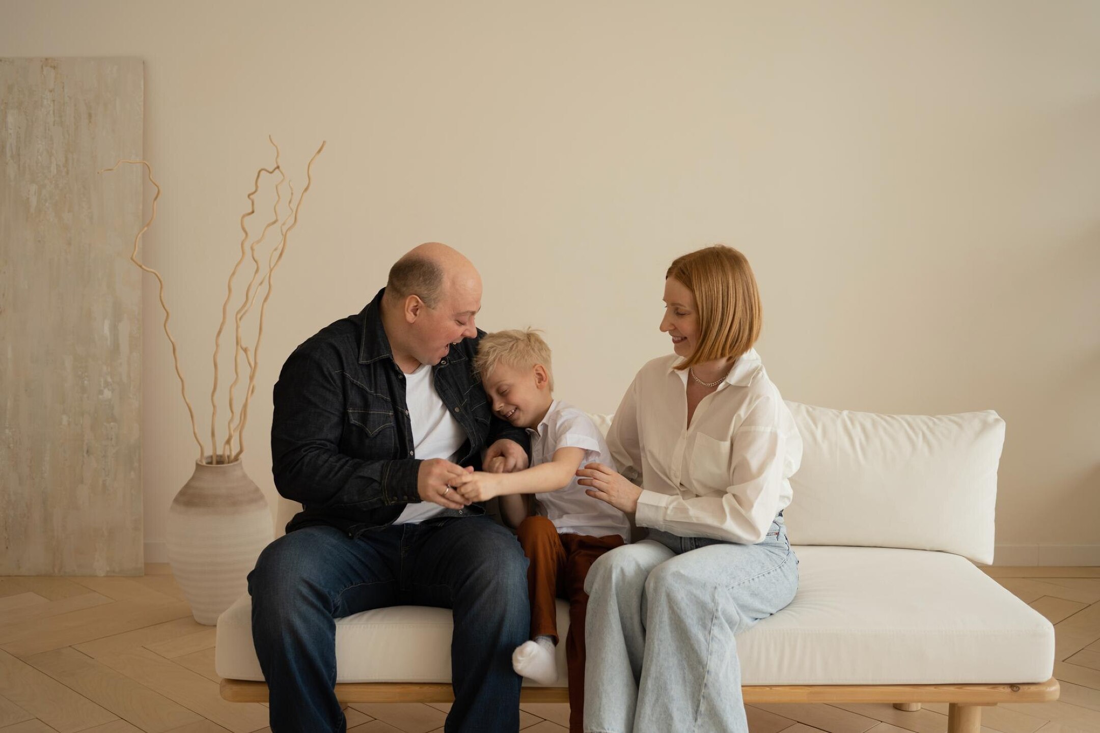 Happy family sitting on sofa in living room Father mother an