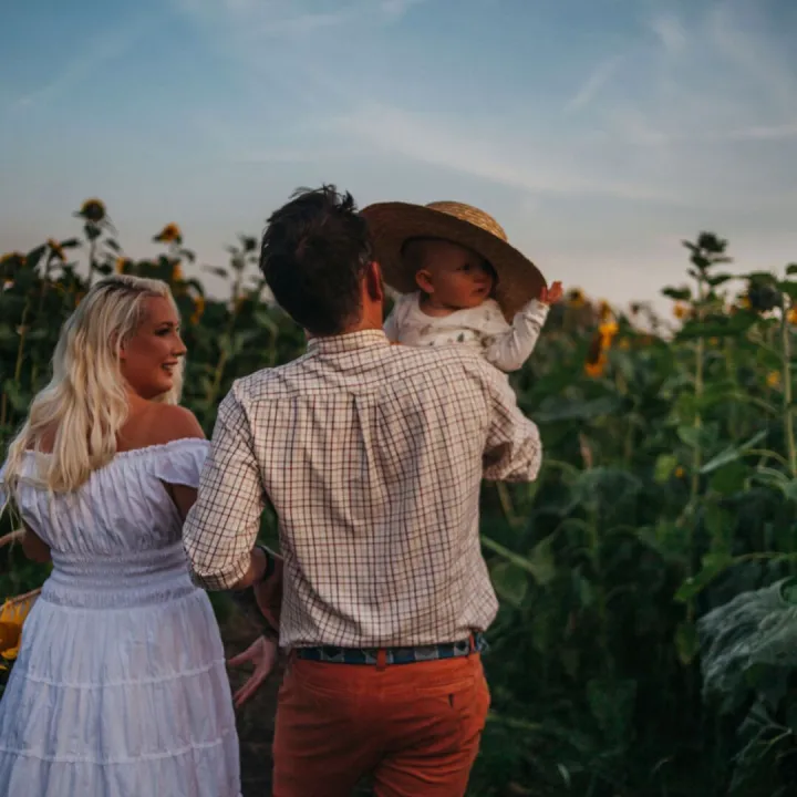 Family Picking Flowers At a Seasonal Farm Event