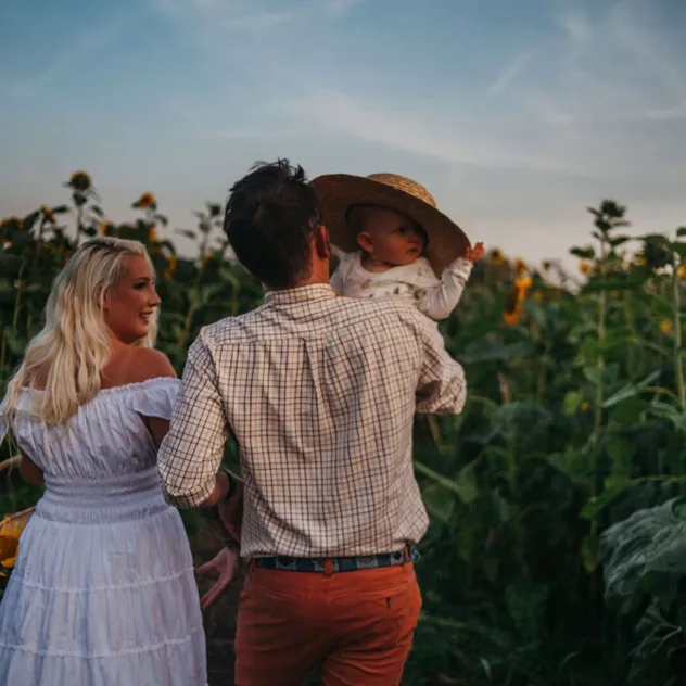 Family Picking Flowers At a Seasonal Farm Event