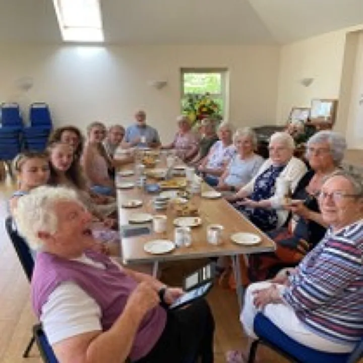 Congregation members sharing refreshments together at Mawla Community Hall