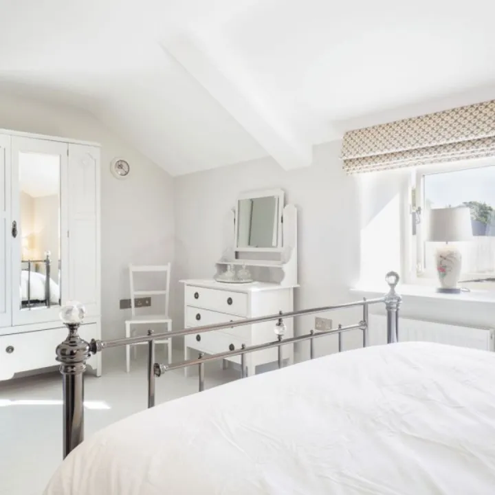 Bedroom one at Otters Retreat with a king size bed and countryside views
