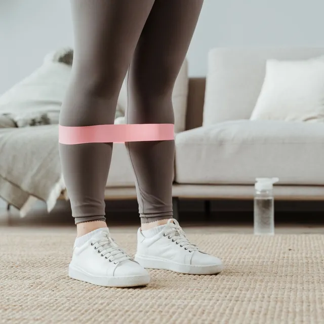 Resistance band worn around the ankles during exercise