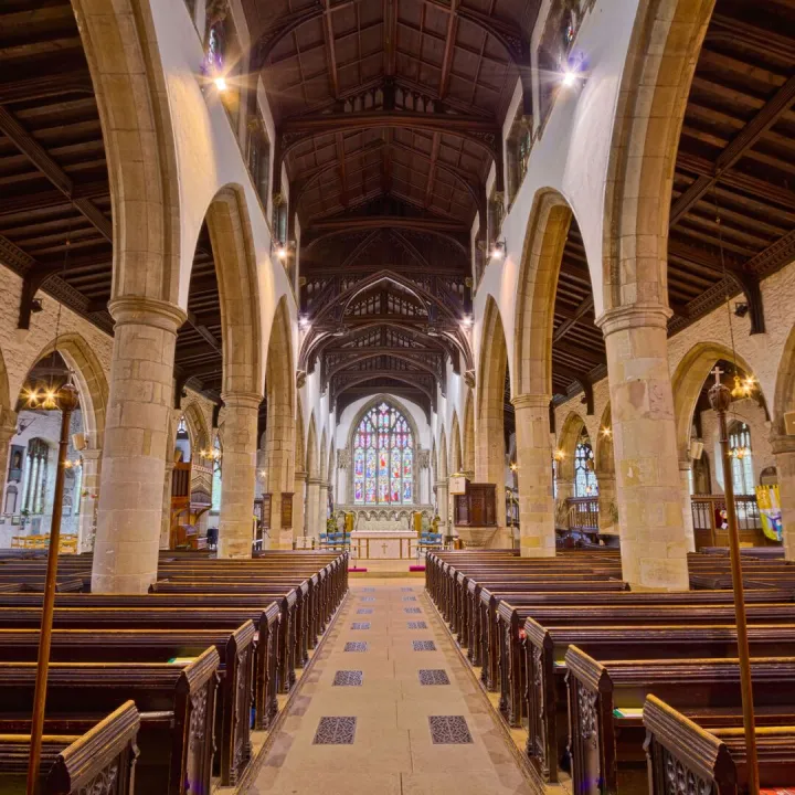 The empty nave and pews of an English parish church before a service
