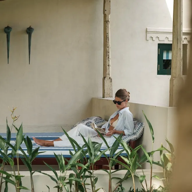 A guest reading in the walled courtyard of the Sigiriya View Suite at Peacock Hill Sigiriya