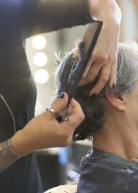 A hairdresser cutting a client’s hair in a salon