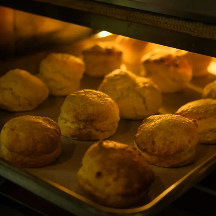 Close-up of freshly baked biscuits turning golden
