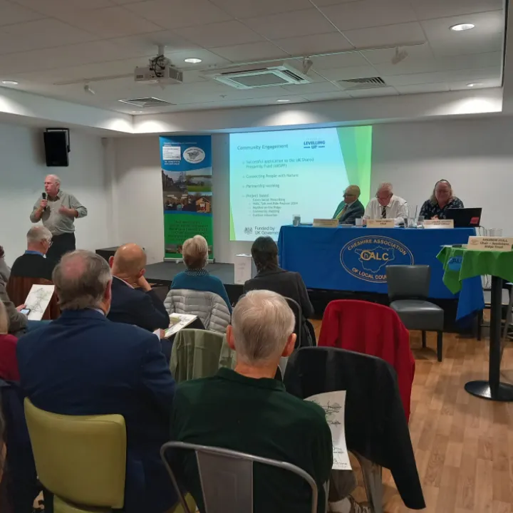 Councillors seated in a meeting hall facing a top table with a ChALC banner