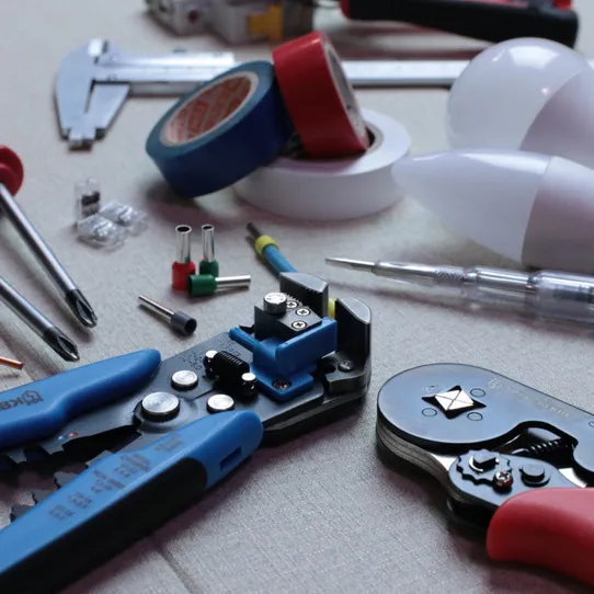 A selection of electrical maintenance tools laid out on a table