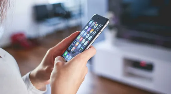 Woman Wearing White V Neck Shirt Using Space Gray Iphone 6