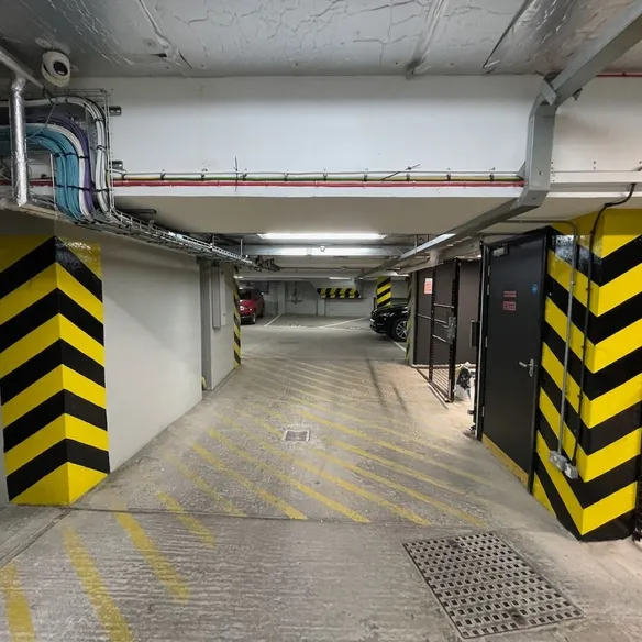 Parking garage entrance with yellow and black striped barriers